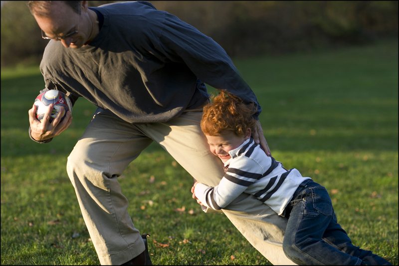 Placing the horizon line between these two players makes the dad feel bigger and the little boy feel smaller, accentuating the discrepancy between their sizes.