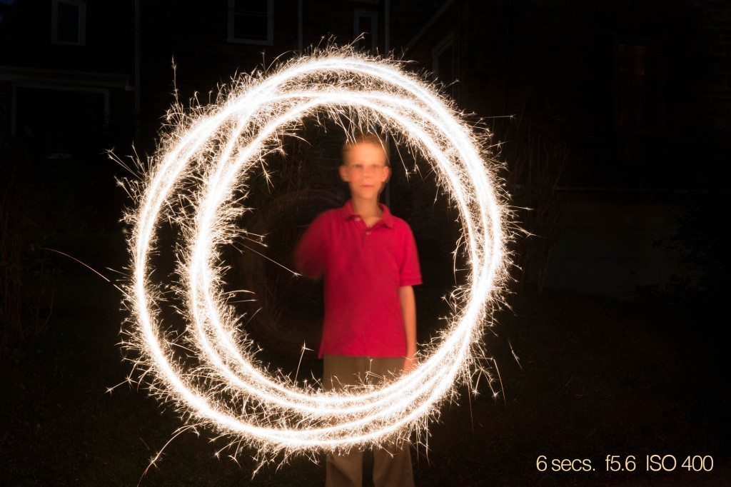 I shot several photographs of Alexander doing three revolutions of the sparkler and this was the sharpest his face ever was. I think this is about as good as it gets at six seconds.