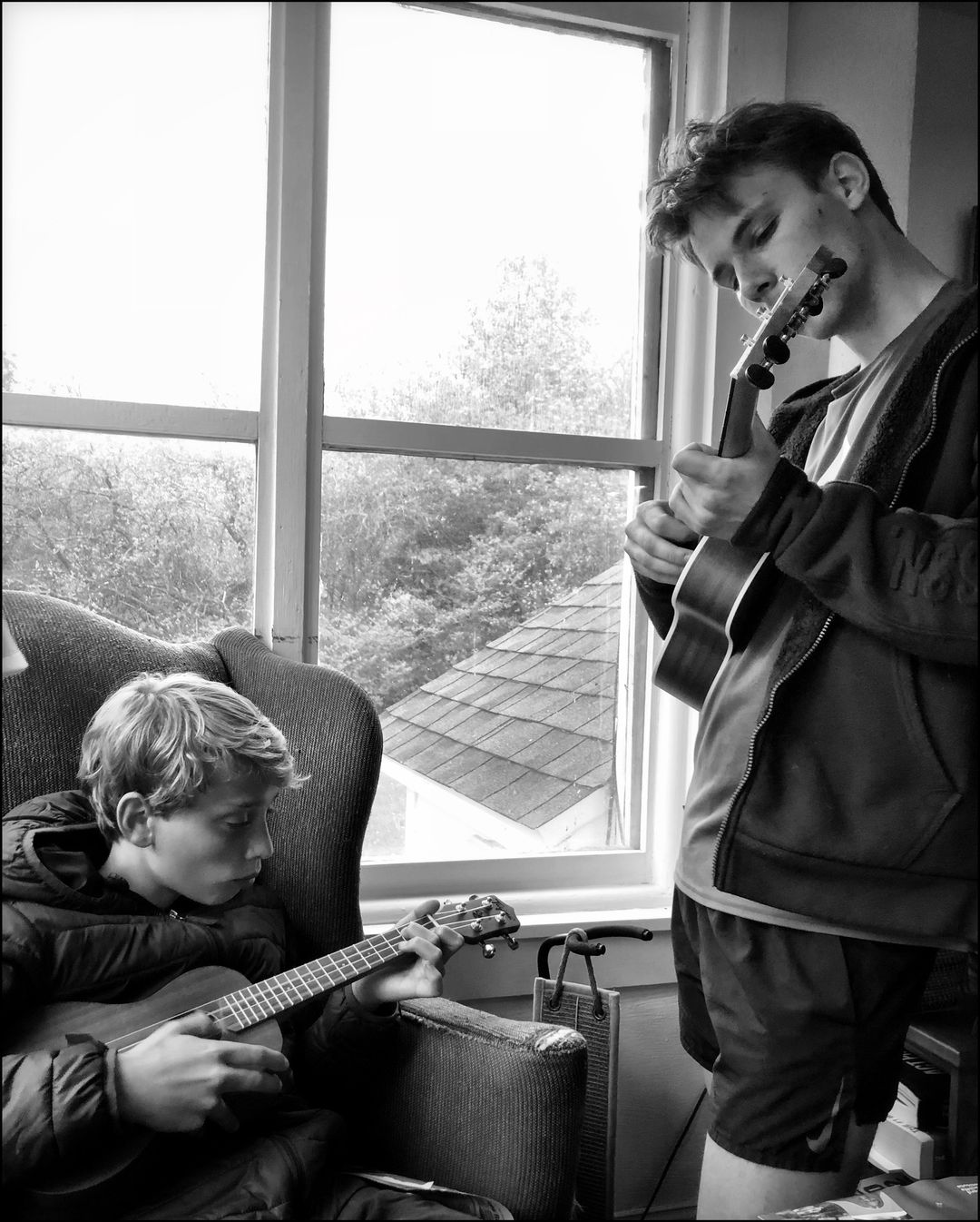 Teddy and Alexander playing their ukuleles